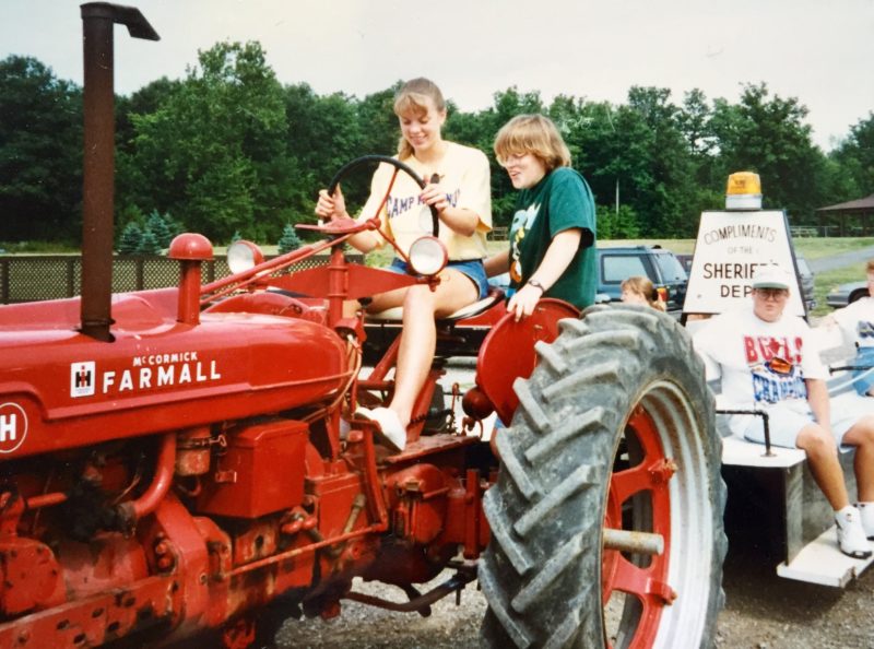 Carrie Vollmer-Sanders, as a high school junior, teaching someone to drive a tractor at a Future Farmers of America event during Edon Days, in Edon, Ohio.
